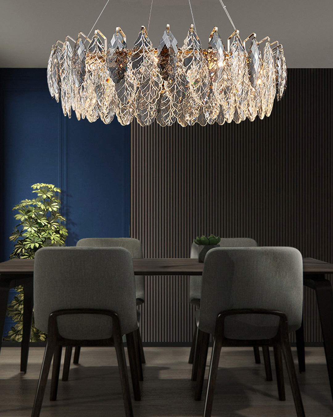 Crystal chandelier hanging above a dining table with chairs in a dimly lit room.